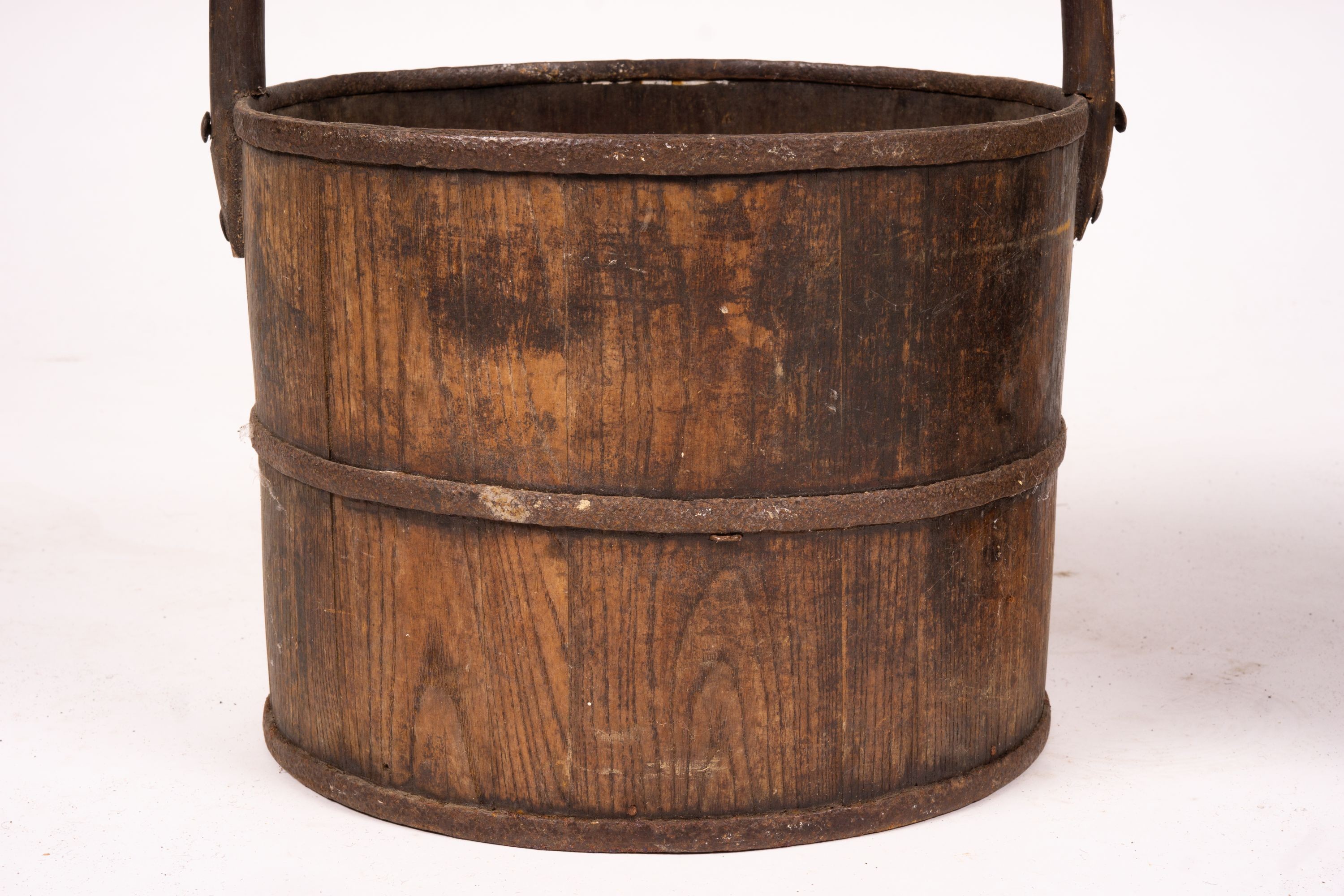 A Chinese staved wood rice carrier together with a circular iron bound staved wood bucket, larger 35cm diameter, height 52cm